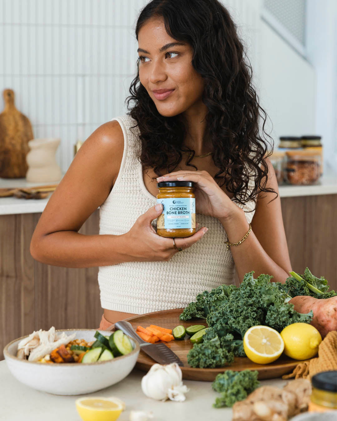 Lady holding chicken bone broth concentrate
