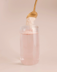 GIF: Berry Bliss Protein Water powder being stirred into a glass of water.