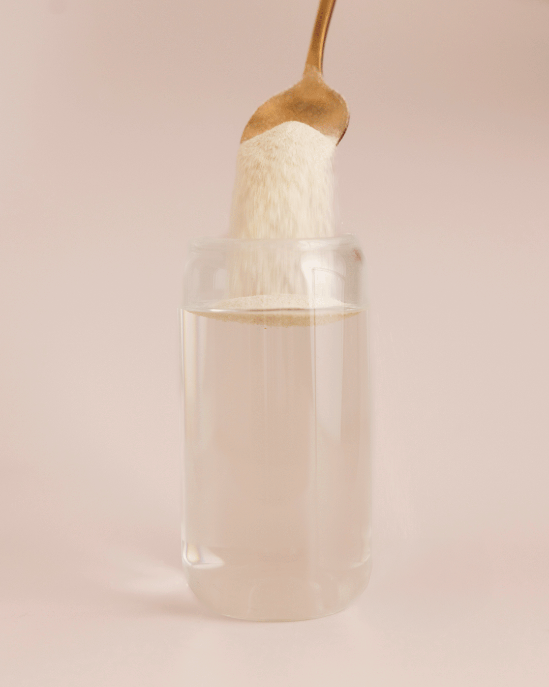 GIF - Protein water powder being stirred into a glass of water